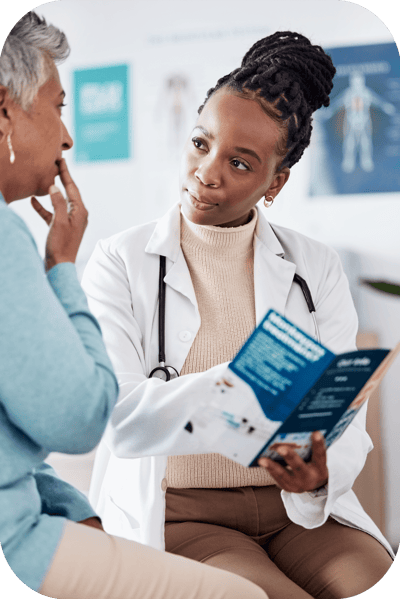 A doctor discussing a brochure with a concerned patient